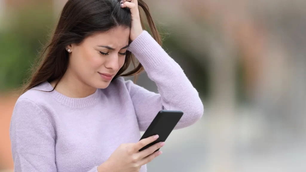 Frustrated employee facing tech issues at a desk with a laptop, highlighting the impact of poor tech support